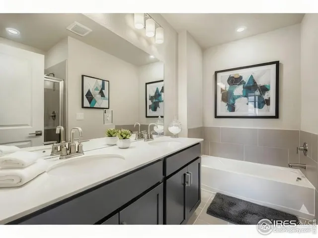a bathroom with a tub a sink and mirror