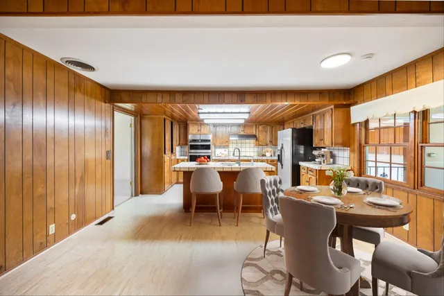 a view of a bedroom with wooden floor and windows