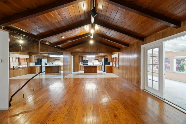 a backyard of a house with stainless steel appliances kitchen island granite countertop a refrigerator and a stove top oven