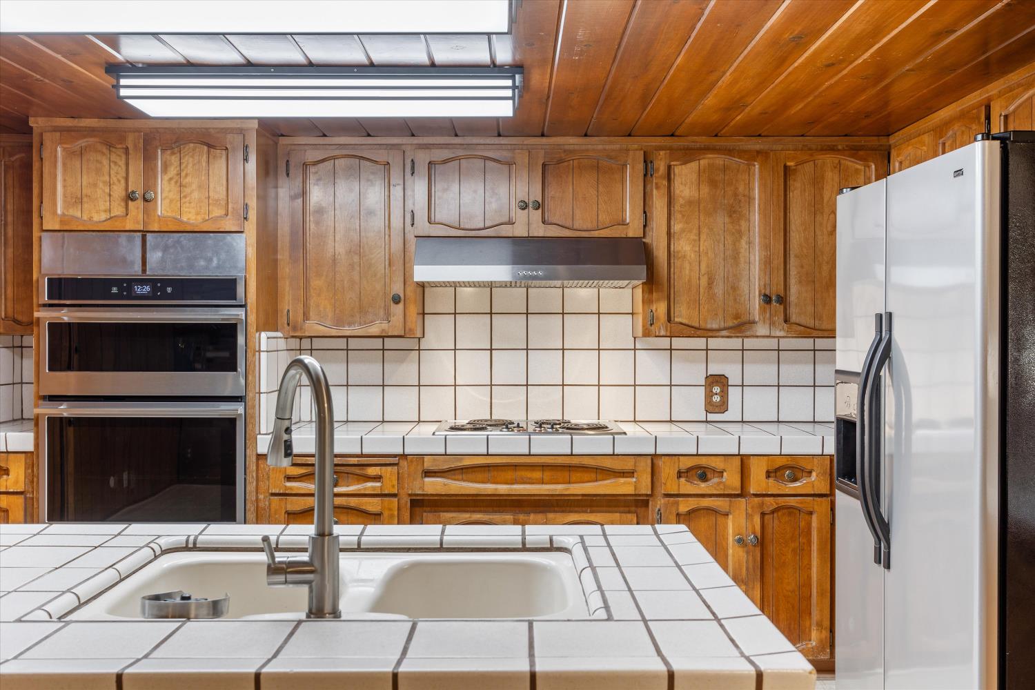 1786 Le Bec Court Lodi, CA 95240 - Photo 24 of 65 a backyard of a house with stainless steel appliances kitchen island granite countertop a refrigerator and a stove top oven