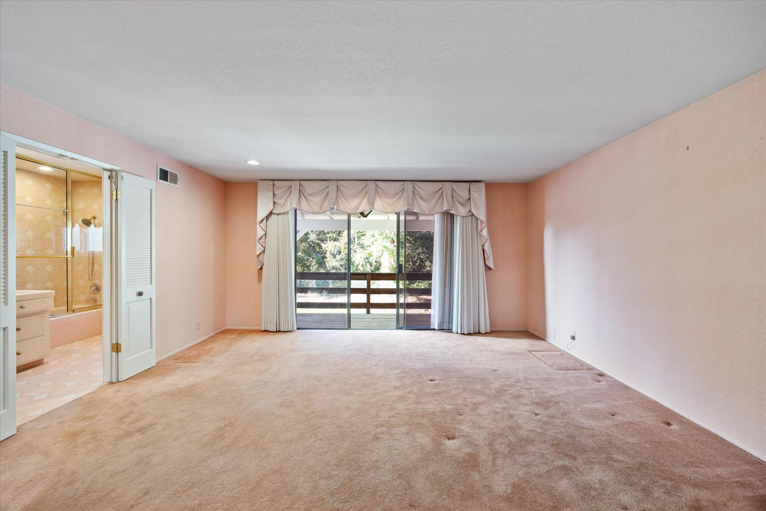 1786 Le Bec Court Lodi, CA 95240 - Photo 27 of 65 a view of an empty room with a window and a kitchen