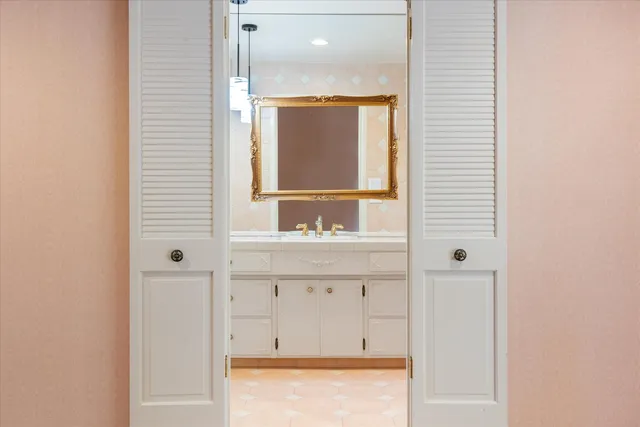 a bathroom with a tub a sink and a large mirror