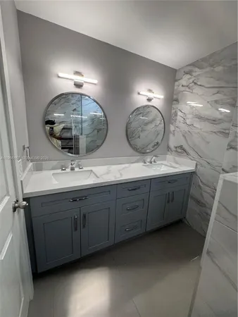 a bathroom with a double vanity sink and a mirror