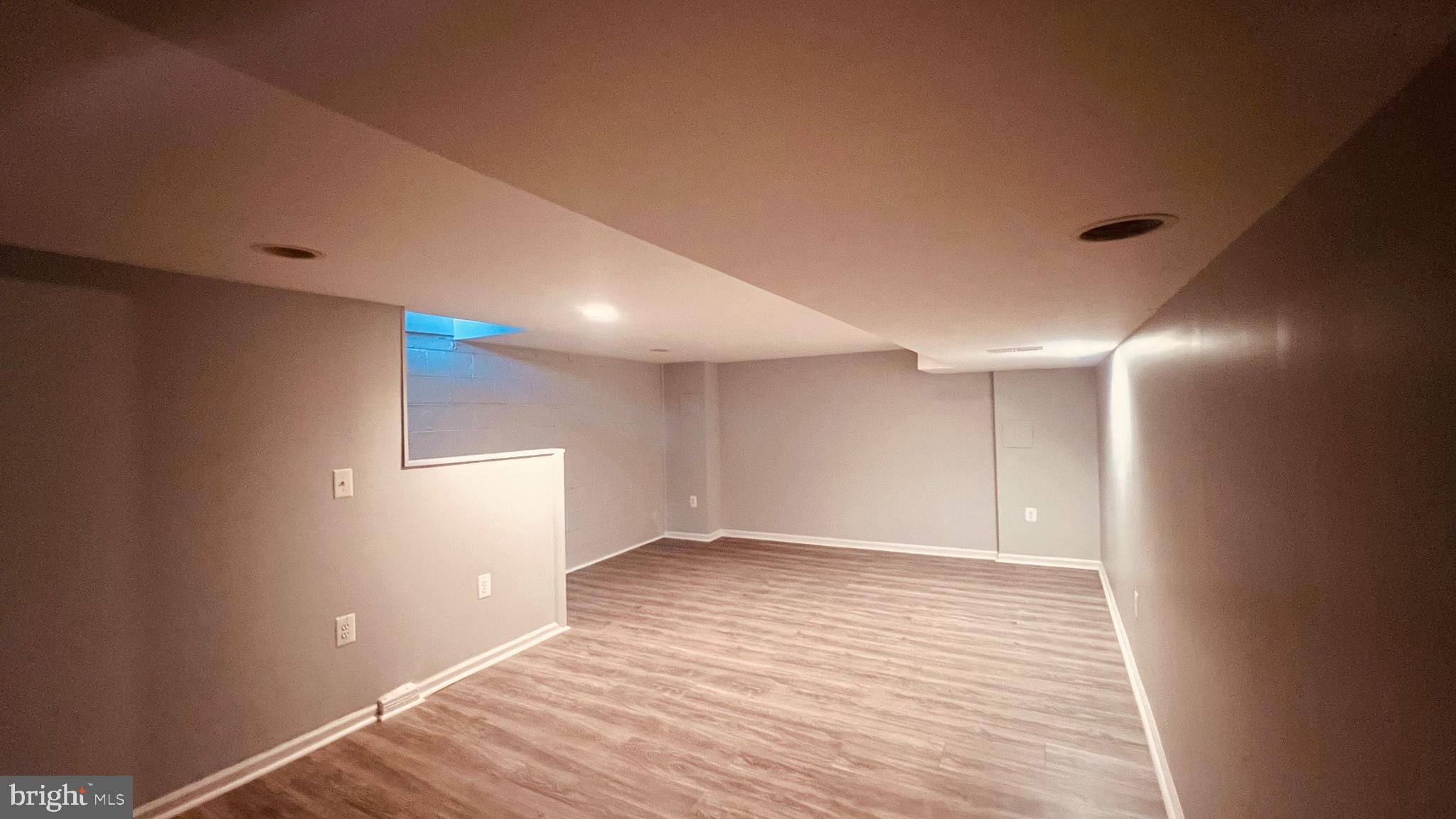 4413 Fenor Road Halethorpe, MD 21227 - Photo 26 of 31 an empty room with wooden floor and windows