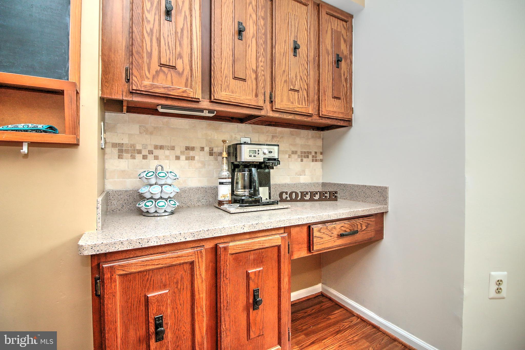 7118 Sontag Way Springfield, VA 22153 - Photo 14 of 36 a kitchen with an oven a cabinets and wooden floor