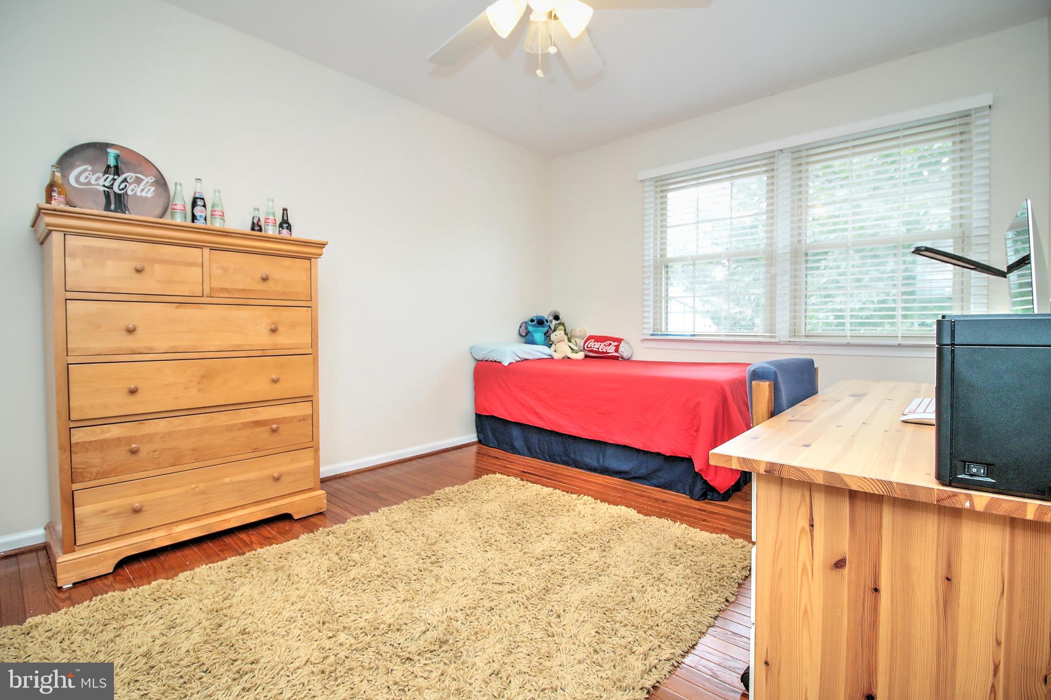 7118 Sontag Way Springfield, VA 22153 - Photo 21 of 36 a bedroom with a bed and a dresser