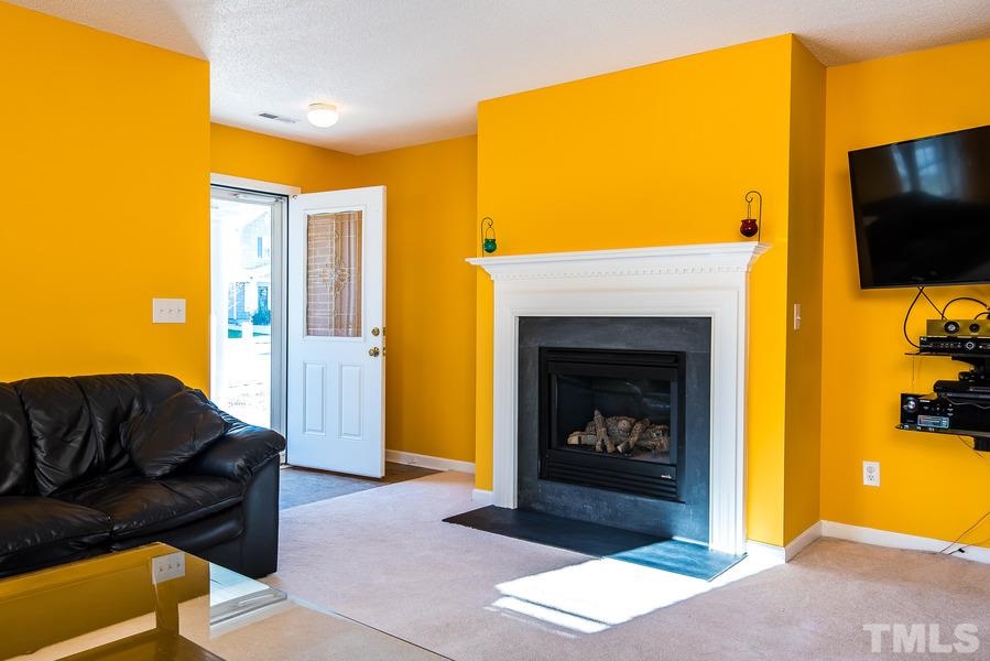 2643 Quarry Springs Road Raleigh, NC 27610 - Photo 2 of 19 a living room with furniture and a fireplace