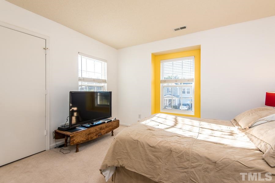 2643 Quarry Springs Road Raleigh, NC 27610 - Photo 15 of 19 a bedroom with a bed and a flat screen tv