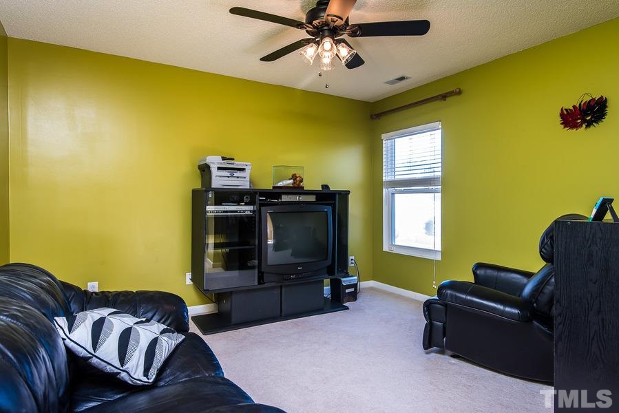 2643 Quarry Springs Road Raleigh, NC 27610 - Photo 16 of 19 a living room with furniture and a flat screen tv