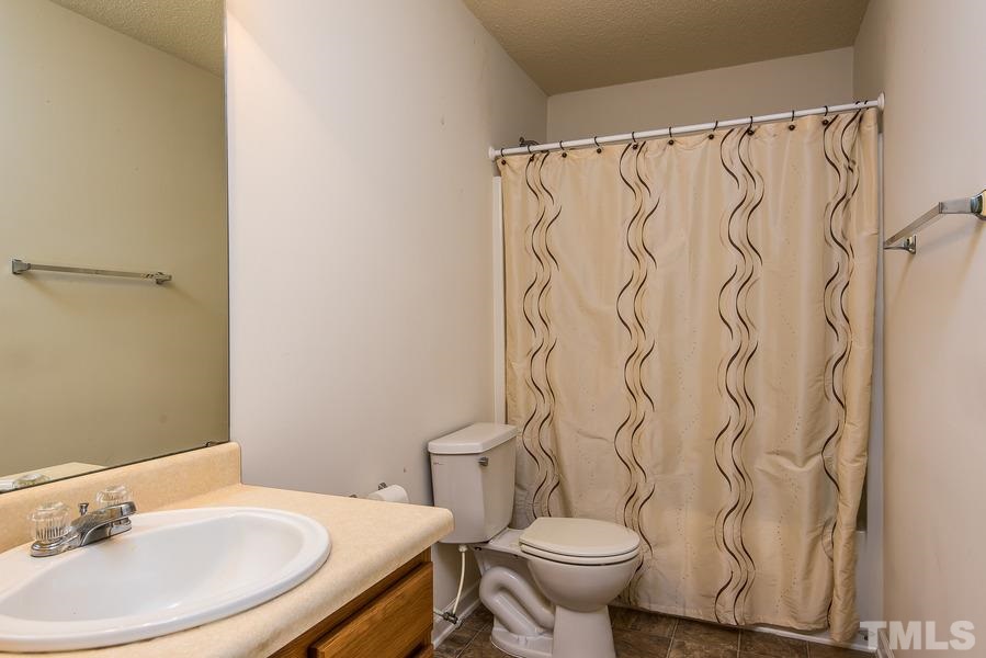2643 Quarry Springs Road Raleigh, NC 27610 - Photo 17 of 19 a bathroom with a sink and a mirror