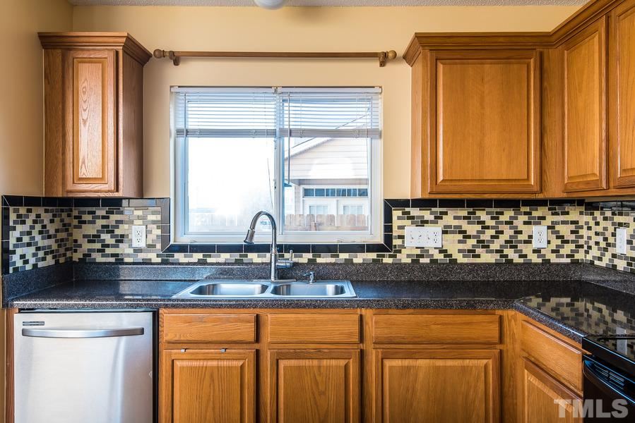 2643 Quarry Springs Road Raleigh, NC 27610 - Photo 7 of 19 a kitchen with a sink a window and cabinets