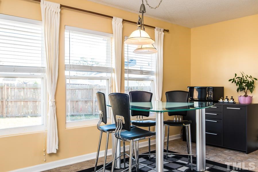2643 Quarry Springs Road Raleigh, NC 27610 - Photo 10 of 19 a dining room with furniture and window