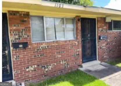 a view of front door of house with yard