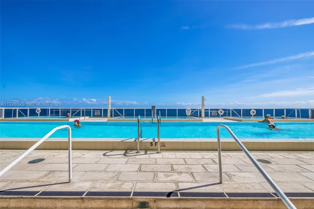 a view of a swimming pool with an outdoor seating