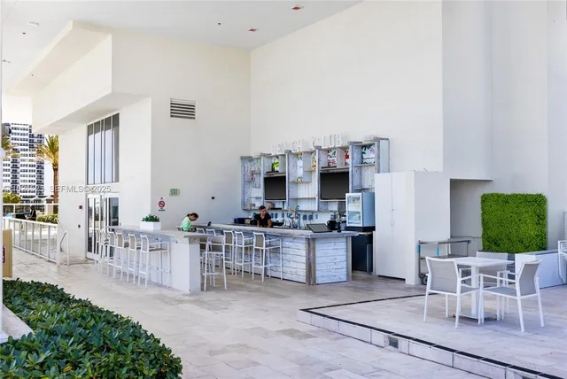 a living room with furniture a chandelier and a dining table