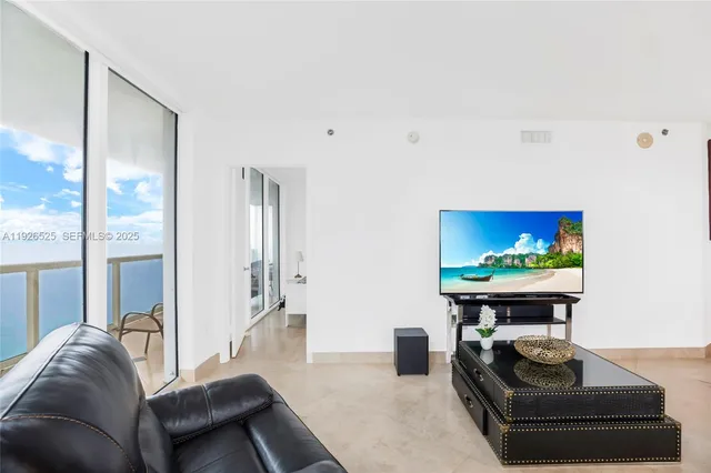 a living room with furniture and a piano