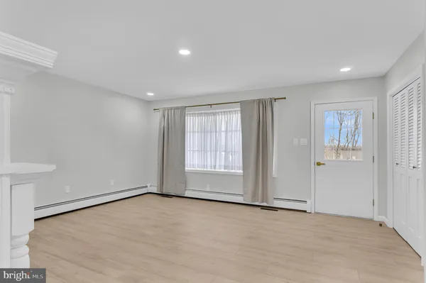 an empty room with windows and closet