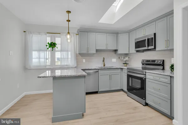 a kitchen with a sink stove and microwave