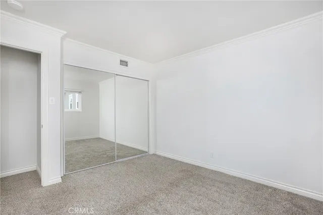 an empty room with mirror in closet