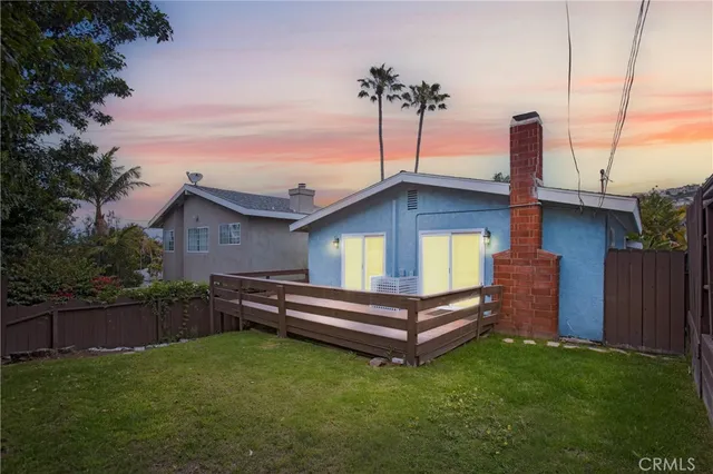 a wooden bench sitting in front of a house