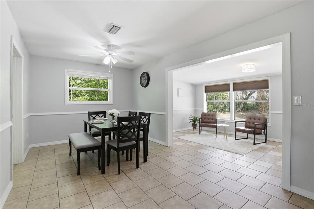3921 Southeast 14th Terrace Gainesville, FL 32641 - Photo 11 of 32 a view of a dining room and livingroom with furniture window and outside view