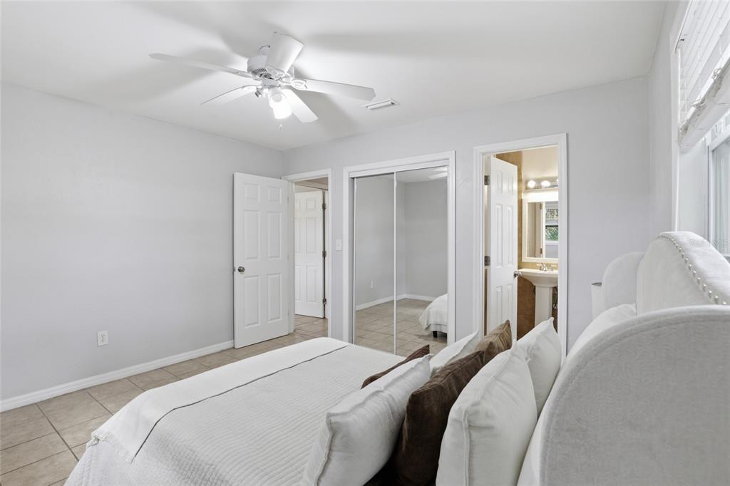 3921 Southeast 14th Terrace Gainesville, FL 32641 - Photo 19 of 32 a bedroom with a bed and a chandelier