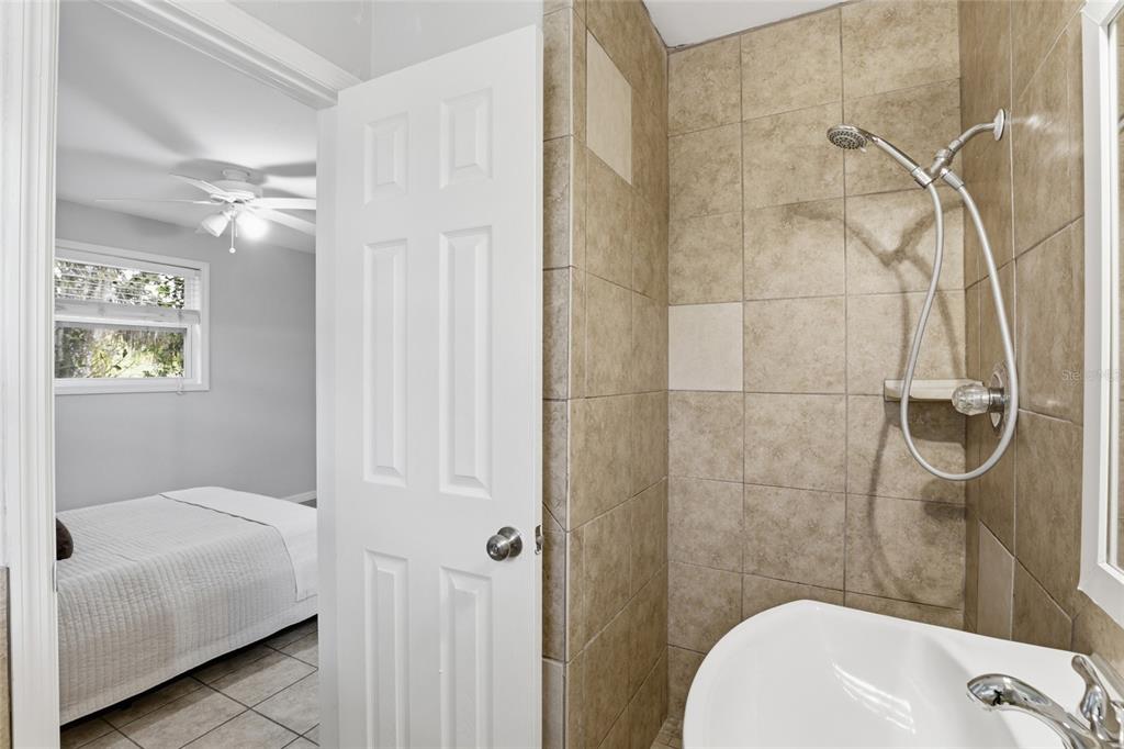 3921 Southeast 14th Terrace Gainesville, FL 32641 - Photo 20 of 32 a bathroom with a sink a toilet and shower