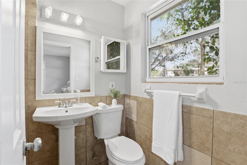 3921 Southeast 14th Terrace Gainesville, FL 32641 - Photo 21 of 32 a bathroom with a toilet sink and mirror