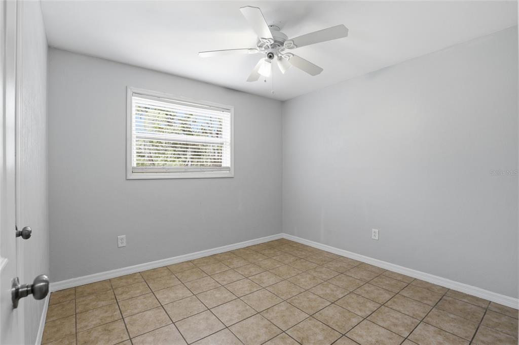 3921 Southeast 14th Terrace Gainesville, FL 32641 - Photo 23 of 32 wooden floor in an empty room with a window