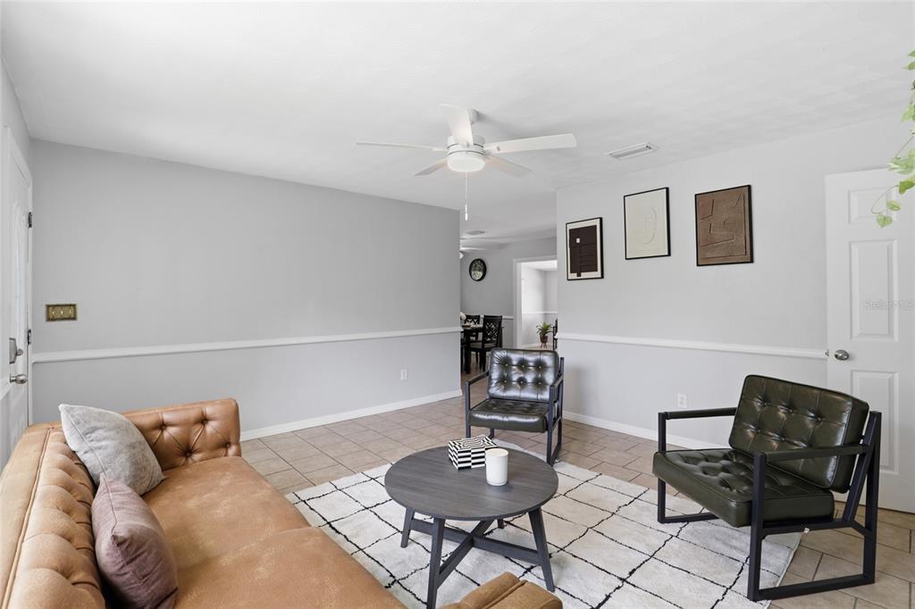 3921 Southeast 14th Terrace Gainesville, FL 32641 - Photo 5 of 32 a living room with furniture and a chair