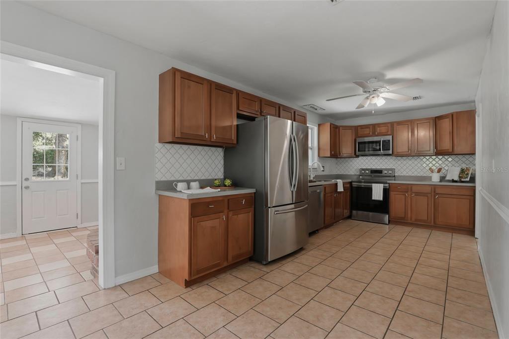 3921 Southeast 14th Terrace Gainesville, FL 32641 - Photo 7 of 32 a kitchen with stainless steel appliances granite countertop a refrigerator sink and cabinets