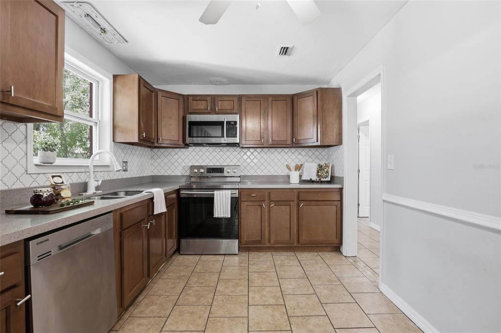 3921 Southeast 14th Terrace Gainesville, FL 32641 - Photo 8 of 32 a kitchen with a sink cabinets and window