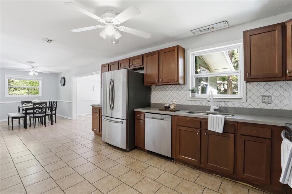 3921 Southeast 14th Terrace Gainesville, FL 32641 - Photo 9 of 32 a kitchen with stainless steel appliances granite countertop a refrigerator and a sink