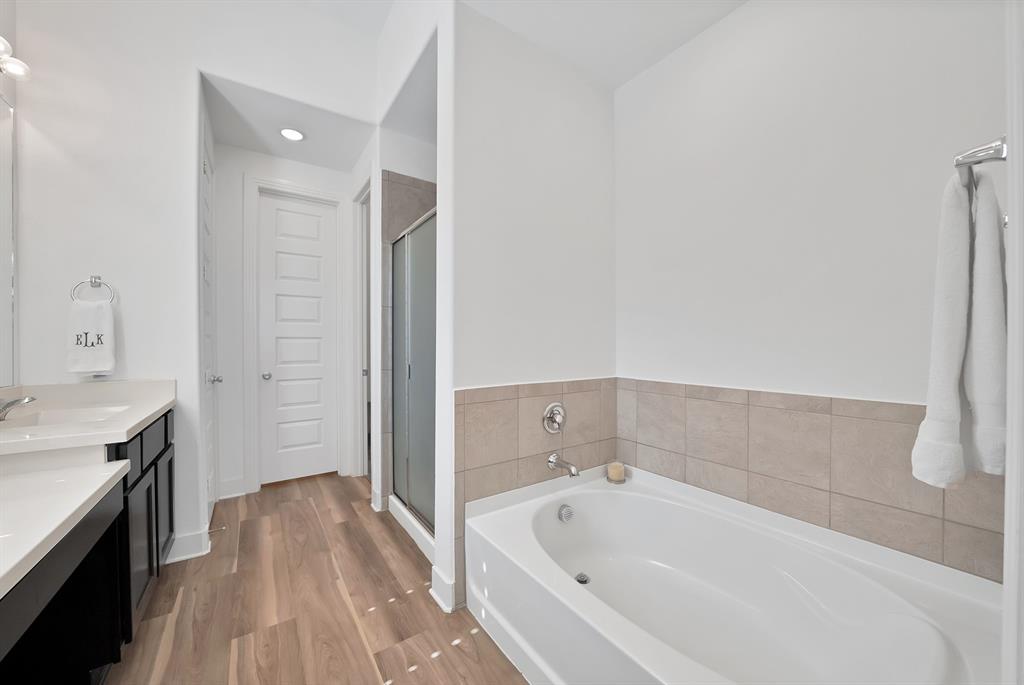 1709 Shetland Road Aubrey, TX 76227 - Photo 20 of 35 a bathroom with a bathtub and a sink