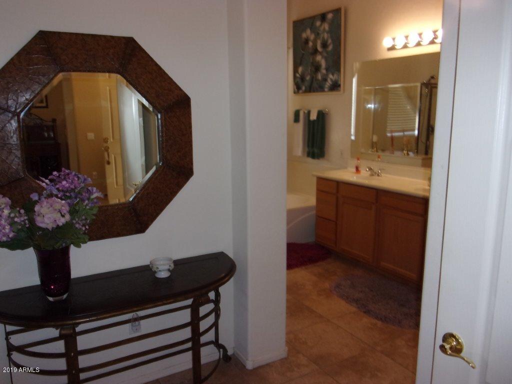 2742 East Harwell Road Gilbert, AZ 85234 - Photo 13 of 45 a bathroom with a sink mirror and vanity
