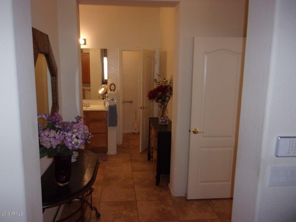 2742 East Harwell Road Gilbert, AZ 85234 - Photo 14 of 45 a room with a dining table and a chandelier