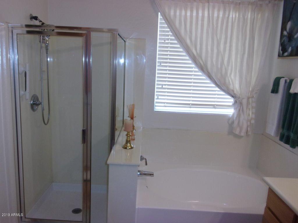 2742 East Harwell Road Gilbert, AZ 85234 - Photo 15 of 45 a bathroom with a bathtub and a shower
