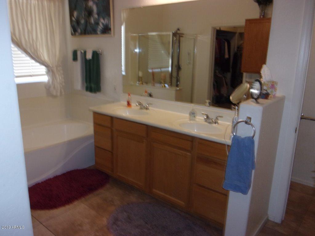 2742 East Harwell Road Gilbert, AZ 85234 - Photo 16 of 45 a bathroom with a double vanity sink and mirror