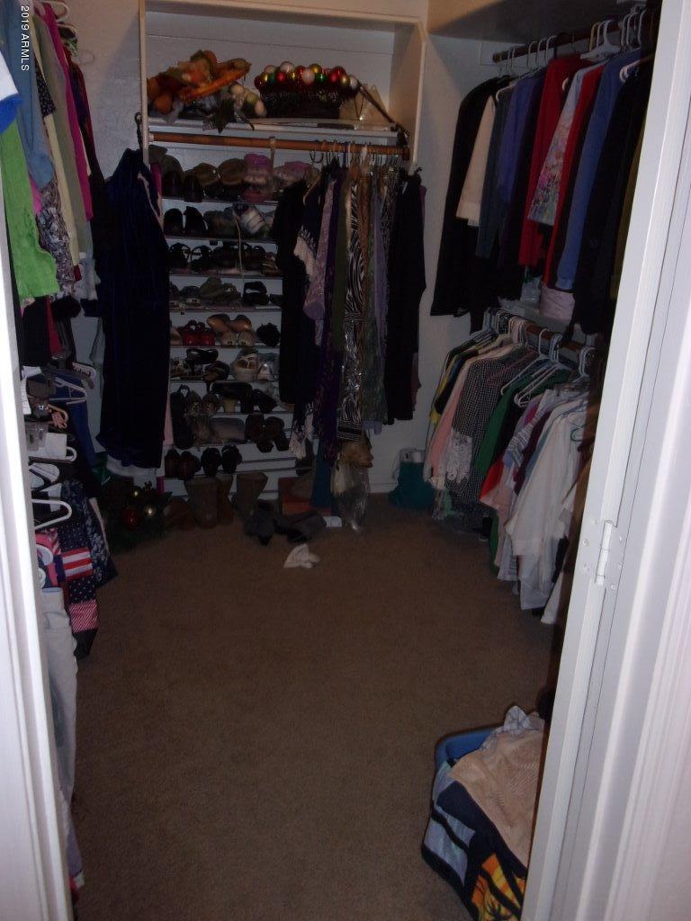 2742 East Harwell Road Gilbert, AZ 85234 - Photo 17 of 45 a view of walk in closet with clothes and shoes