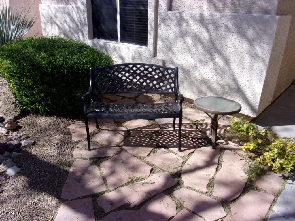2742 East Harwell Road Gilbert, AZ 85234 - Photo 22 of 45 a view of a chairs and table in backyard