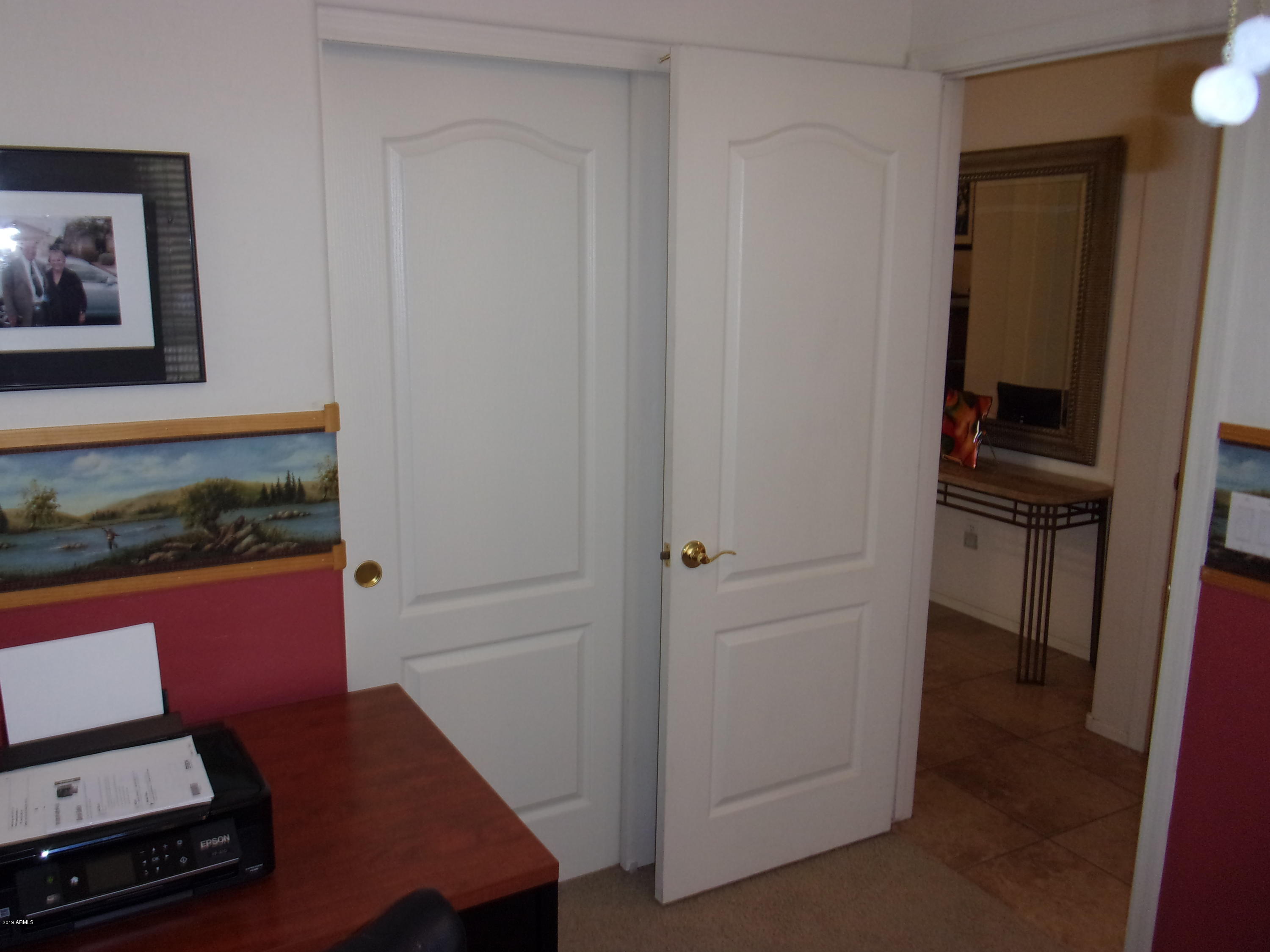 2742 East Harwell Road Gilbert, AZ 85234 - Photo 29 of 45 a view of a hallway with workspace and mirror