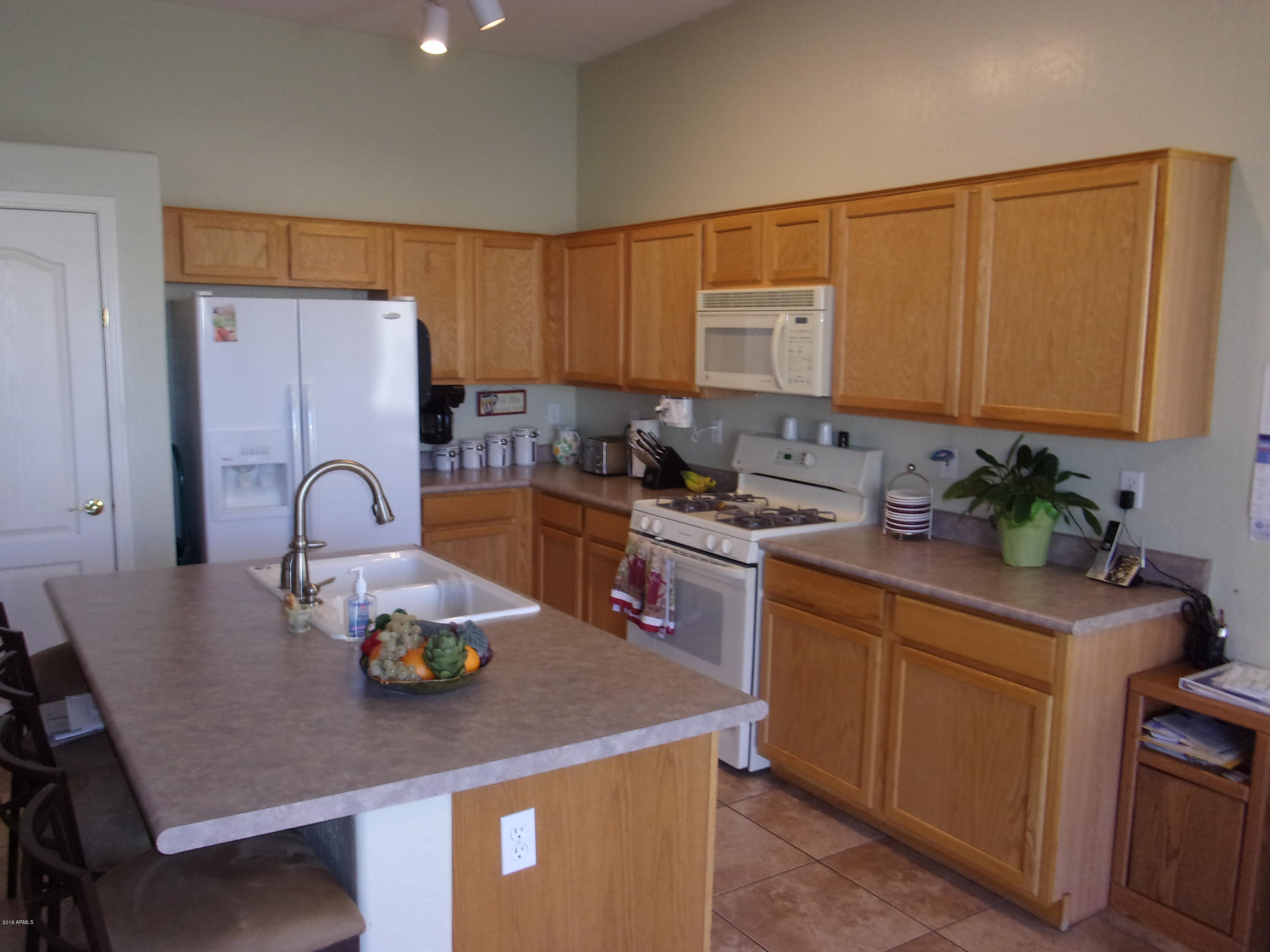 2742 East Harwell Road Gilbert, AZ 85234 - Photo 3 of 45 a kitchen with sink a stove and cabinets