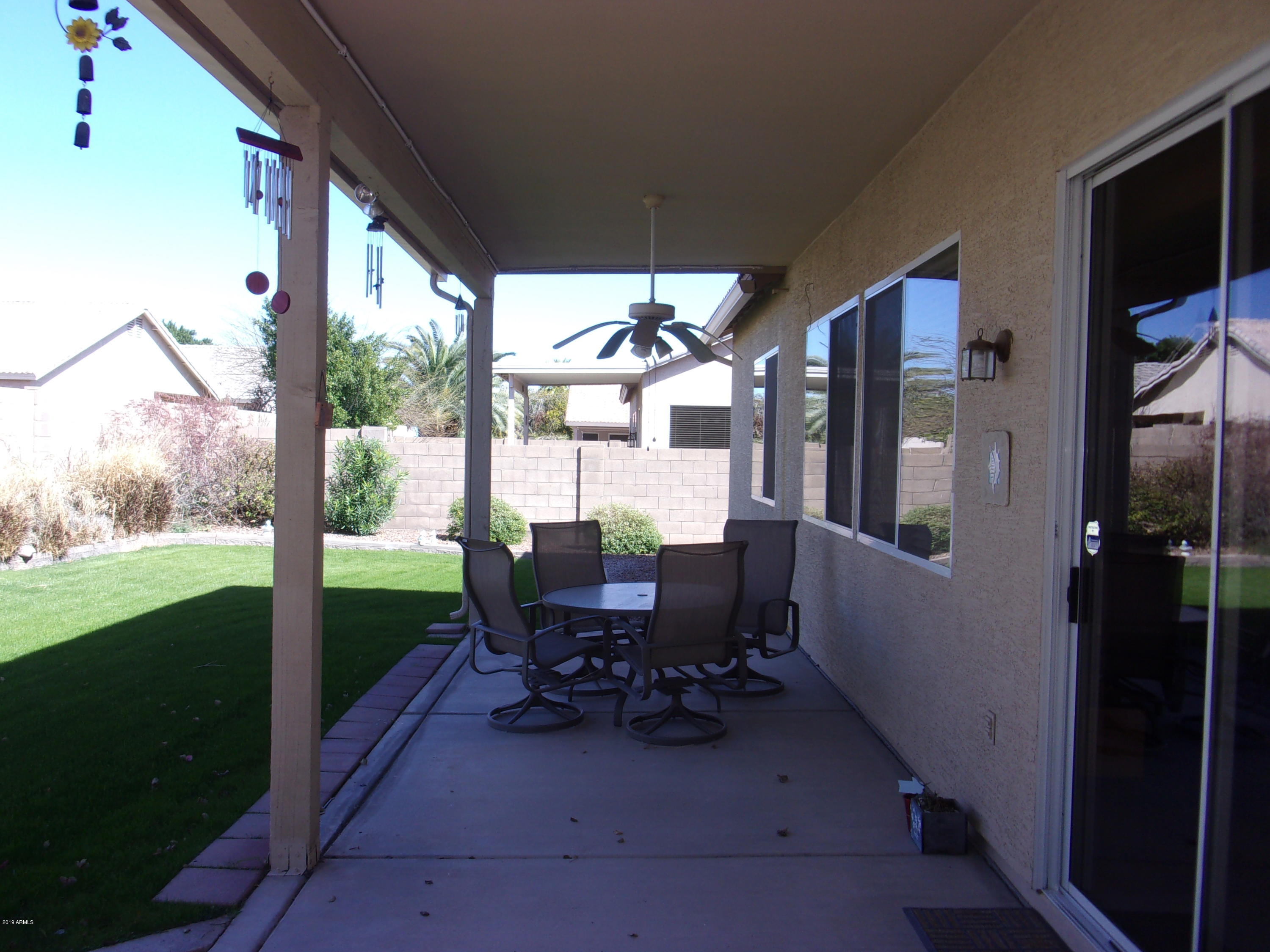 2742 East Harwell Road Gilbert, AZ 85234 - Photo 33 of 45 a view of a porch with chairs and backyard