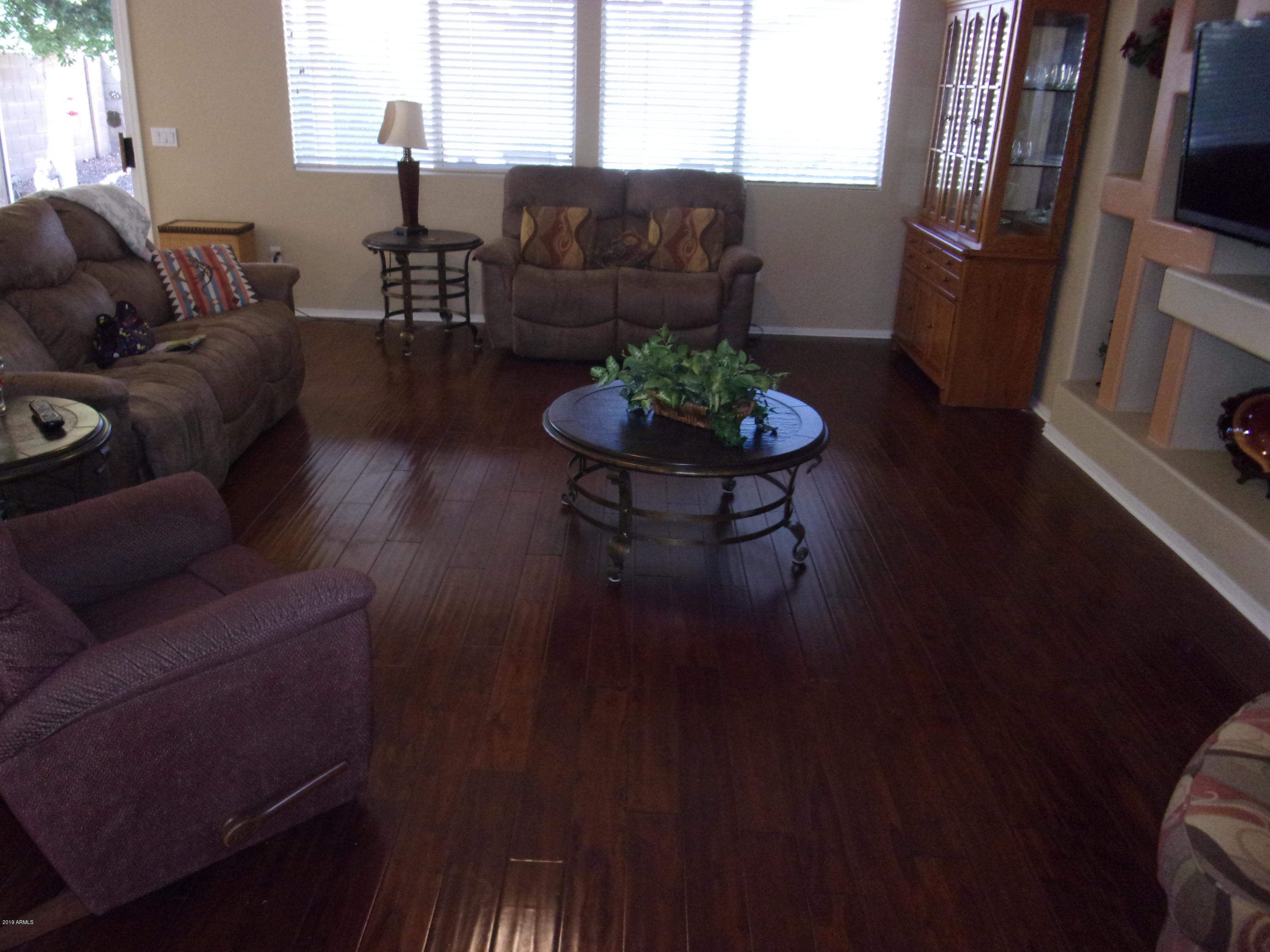 2742 East Harwell Road Gilbert, AZ 85234 - Photo 5 of 45 a living room with furniture and a wooden floor