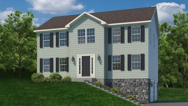 a brick house with garden in front of it