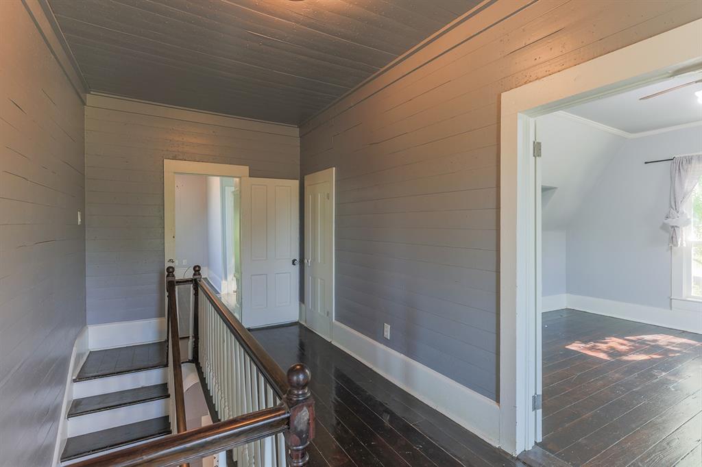 453 East Marshall Street Van Alstyne, TX 75495 - Photo 18 of 30 a view of a hallway with wooden floor and staircase