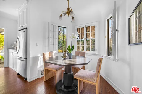 a kitchen with white cabinets and appliances