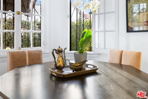 a kitchen with granite countertop a sink cabinets stainless steel appliances and a window