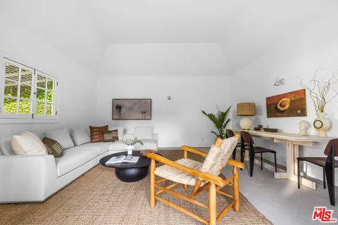 a picture of a room with a white wall and a large mirror