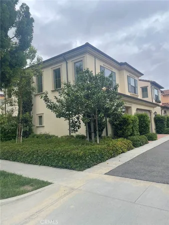 a front view of a house with a yard and trees
